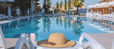 Seasonal outdoor pool, open 11:00 AM to 8:30 PM, pool umbrellas