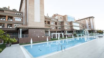 Seasonal outdoor pool, open 11:00 AM to 8:30 PM, pool umbrellas