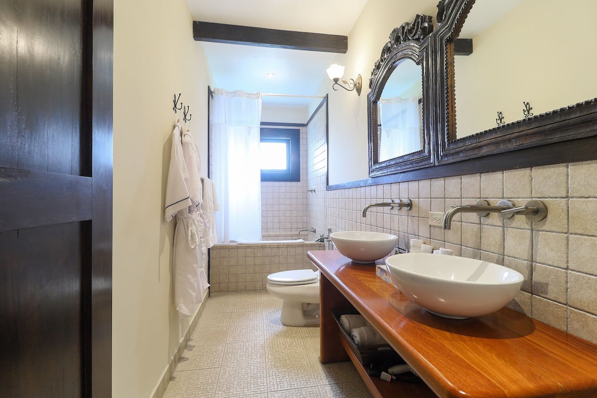 junior suite, 1 king bed | bathroom | hair dryer, bathrobes, slippers, towels