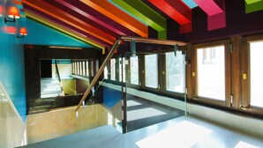 A modern interior with a staircase, large windows, and a colorful ceiling. - Hotel Ca' Zusto Venezia (Venice)