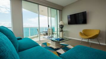 Apartamento Deluxe, varias camas, vistas al mar | Zona de estar | Una televisión