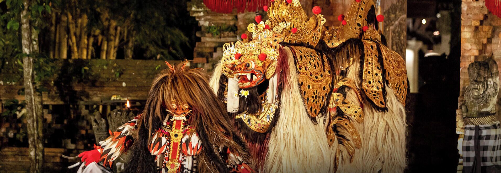 A traditional mask with intricate designs and a headdress with red and gold accents.