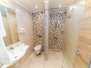 A modern bathroom with a glass-enclosed shower, a white sink, and a toilet. - Hotel Zoo Sofia (Sofia)