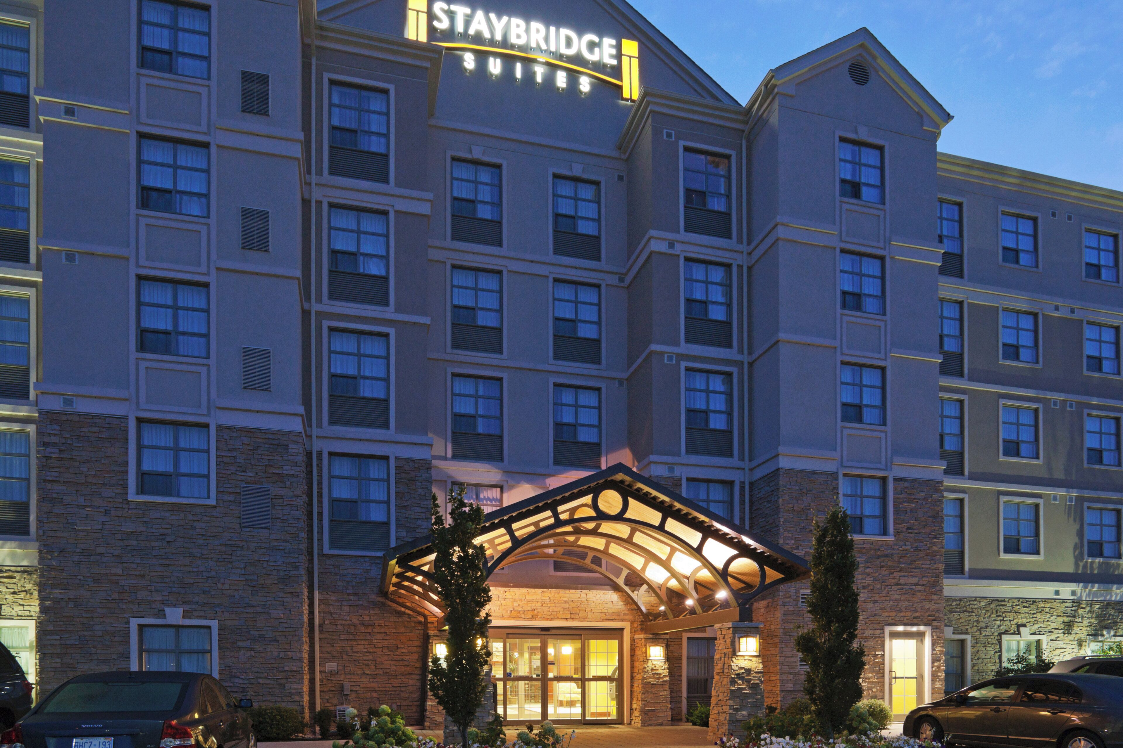 A multi-story hotel with a prominent sign reading 'Staybridge Suites.'