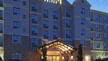A multi-story hotel with a prominent sign reading 'Staybridge Suites.'