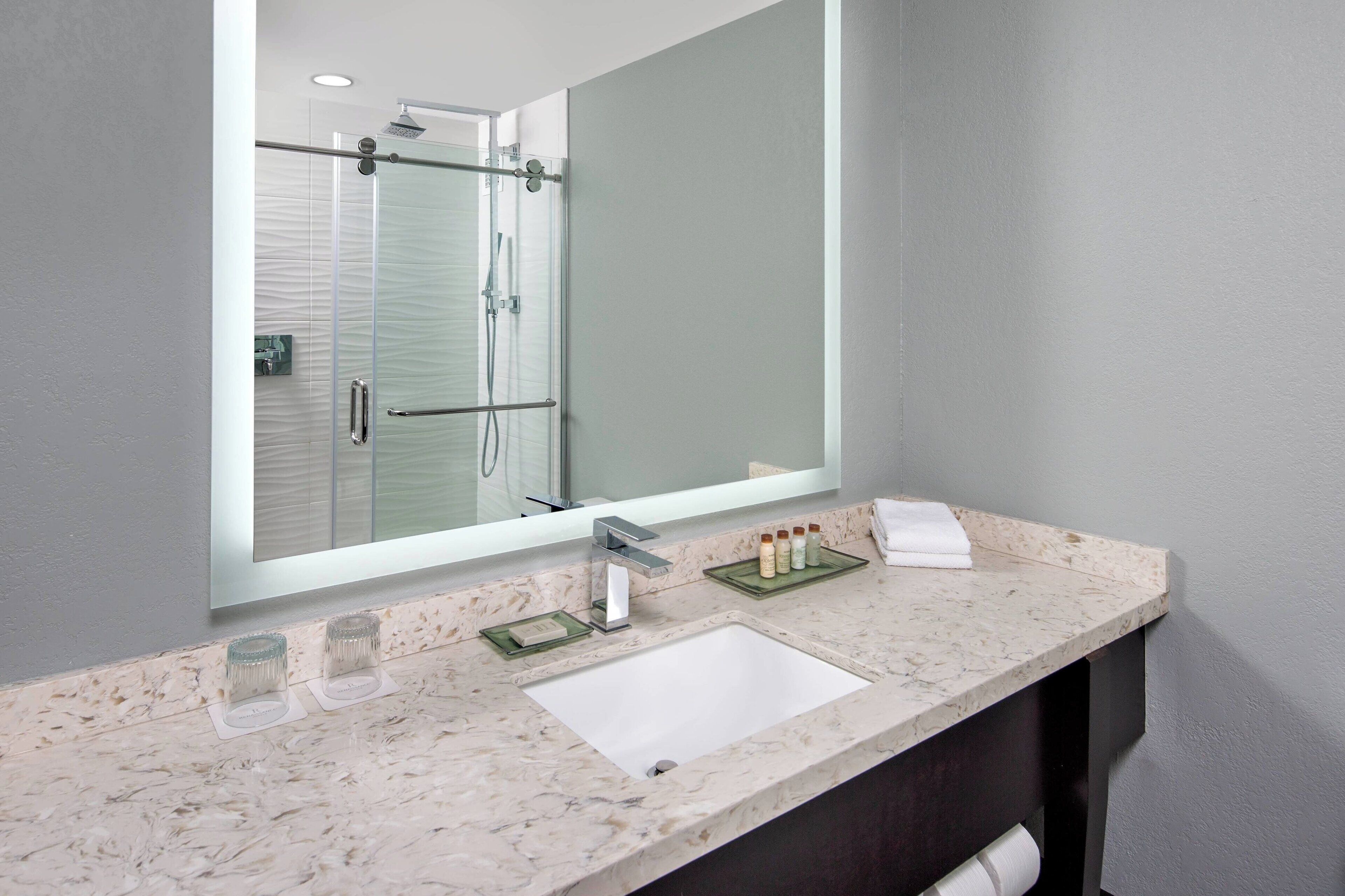 combined shower/bathtub, designer toiletries, hair dryer, towels