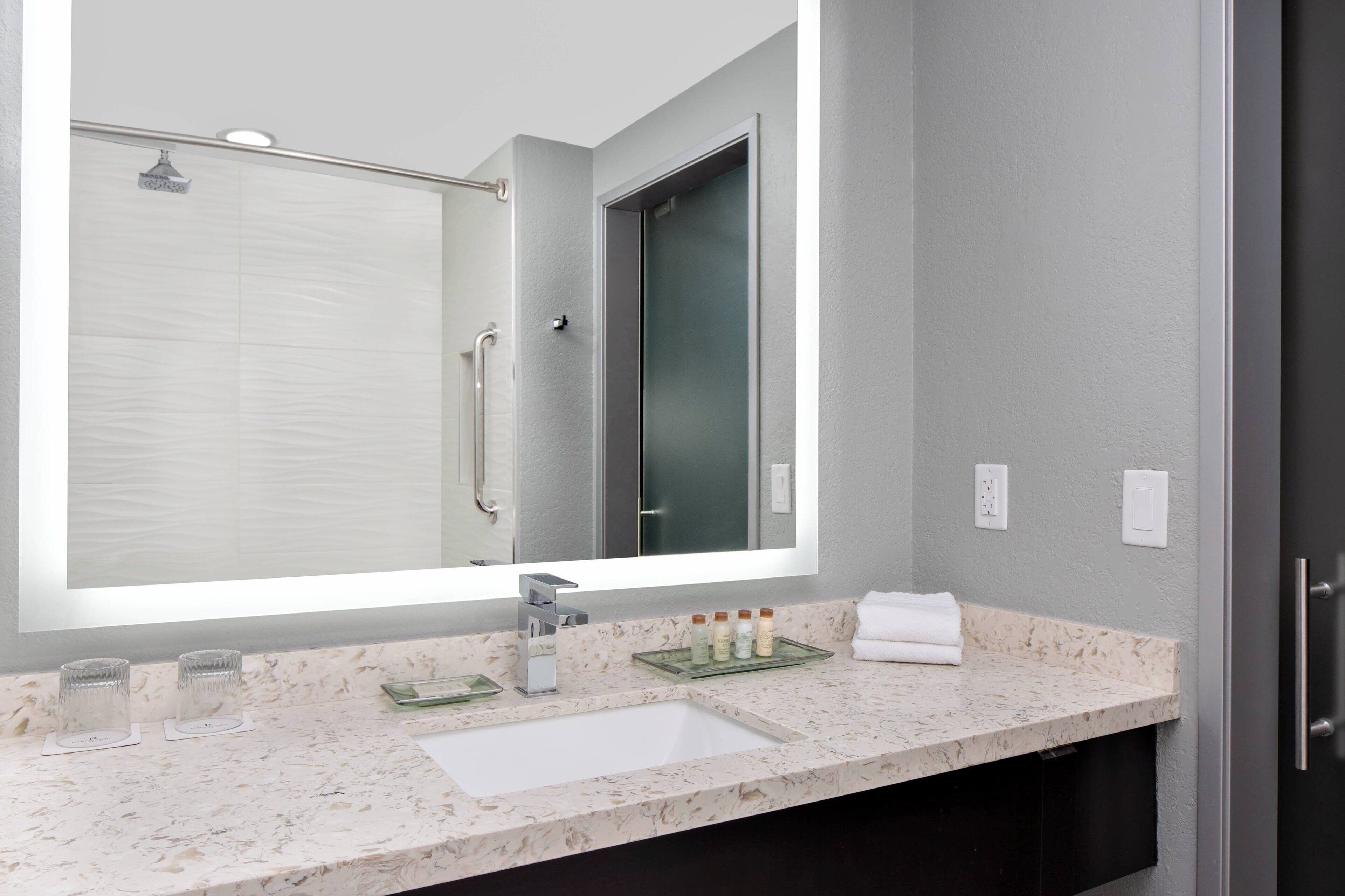 combined shower/bathtub, designer toiletries, hair dryer, towels