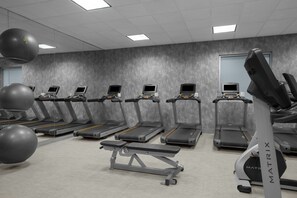 A gym with treadmills, exercise balls, and a bench. - Renaissance Indianapolis North Hotel (Carmel)