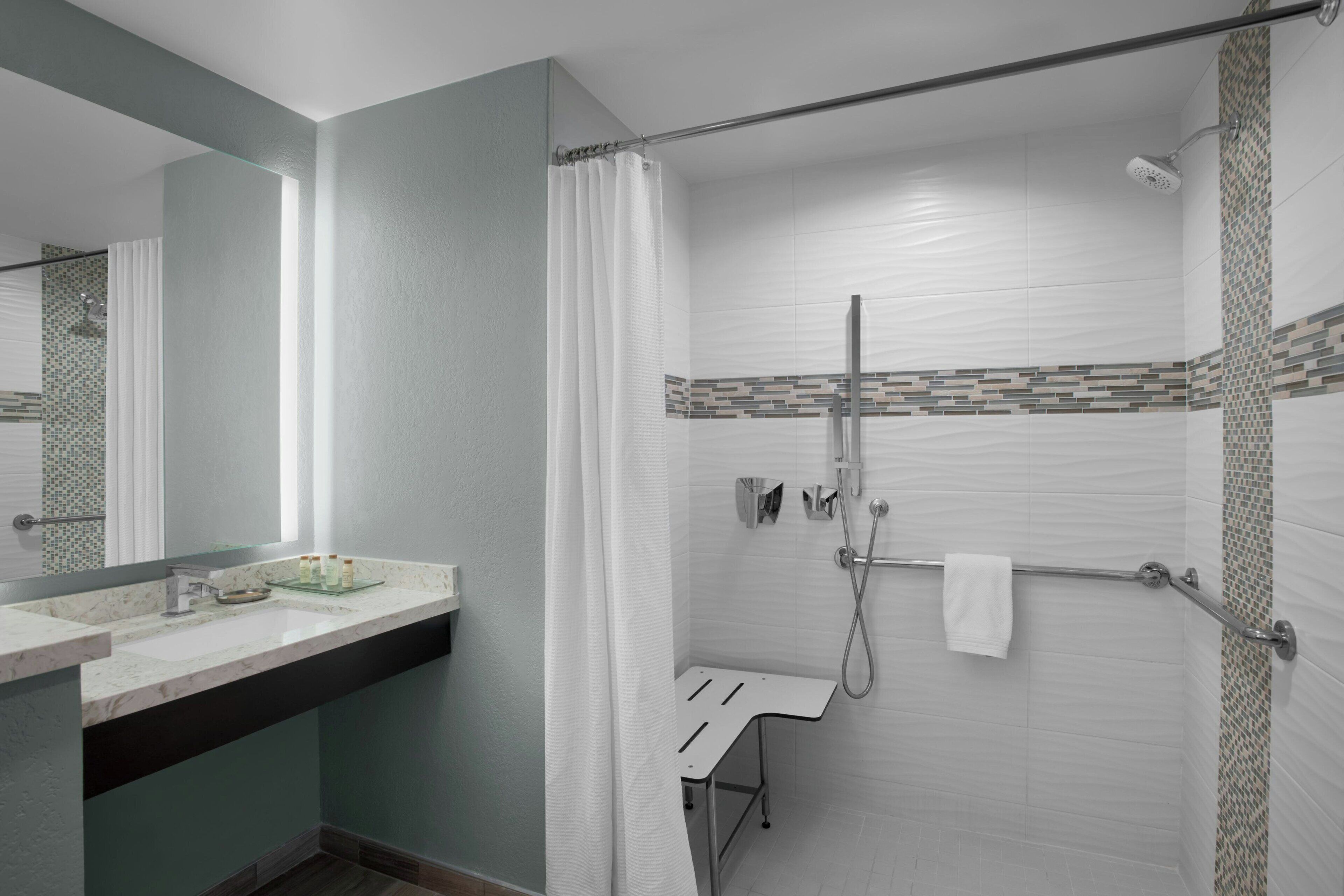 combined shower/bathtub, designer toiletries, hair dryer, towels