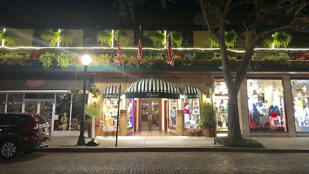 A storefront with a sign reading "Jewel's Hotel" and "Originals."