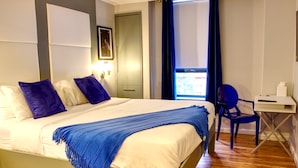 A neatly arranged bedroom with a bed, a desk, and a chair. - The Ridge Hotel (New York)