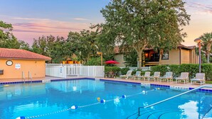 A swimming pool with a lifeguard chair, lounge chairs, and a fence. - Alhambra Villas by Coolvacay (Kissimmee)