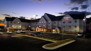 A TownePlace Suites Marriott hotel with a parking lot and multiple vehicles. - TownePlace Suites by Marriott Huntsville (Huntsville)