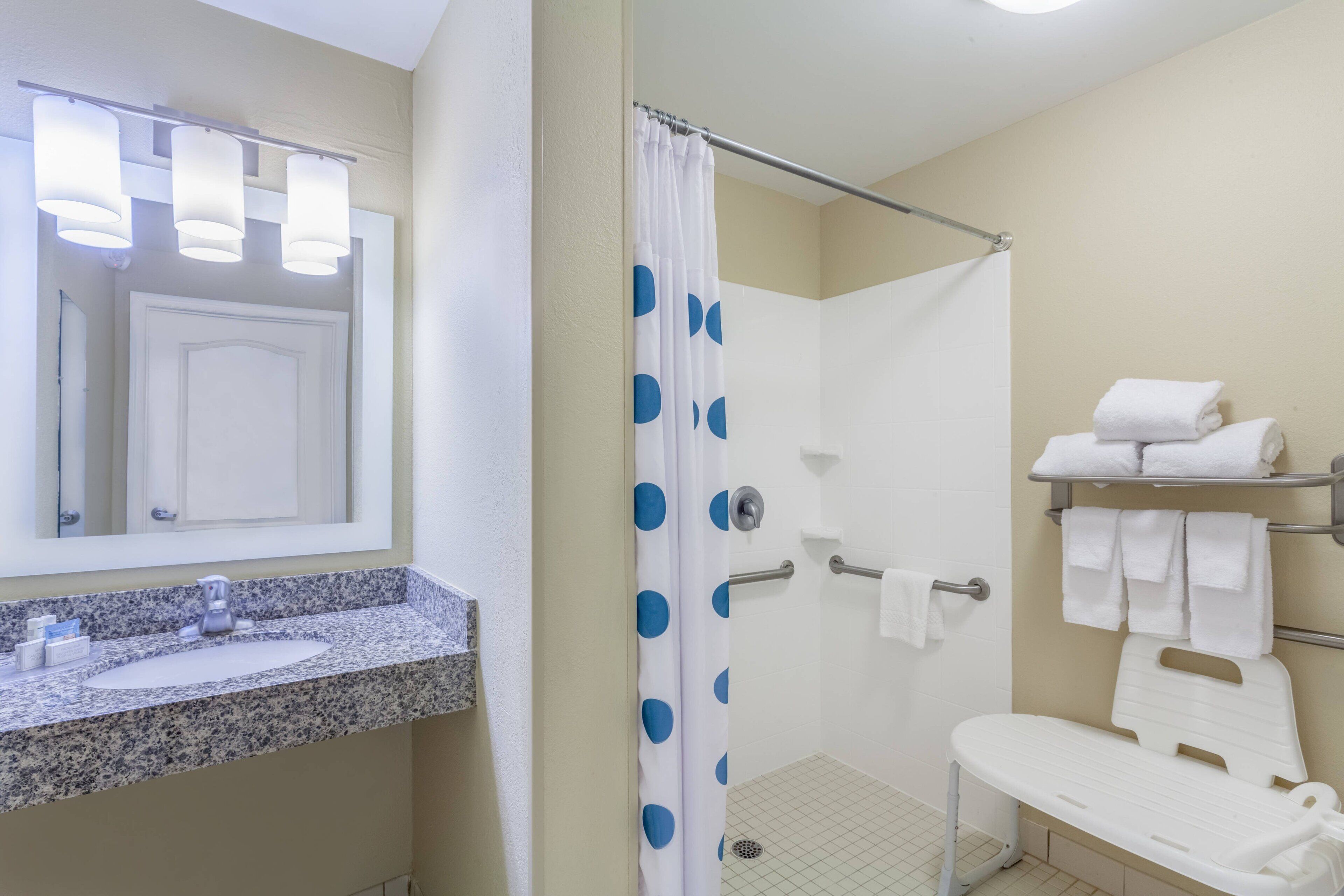 studio suite, 1 king bed with sofa bed (mobility/hearing access, roll-in shwr) | bathroom | combined shower/bathtub, hair dryer, towels