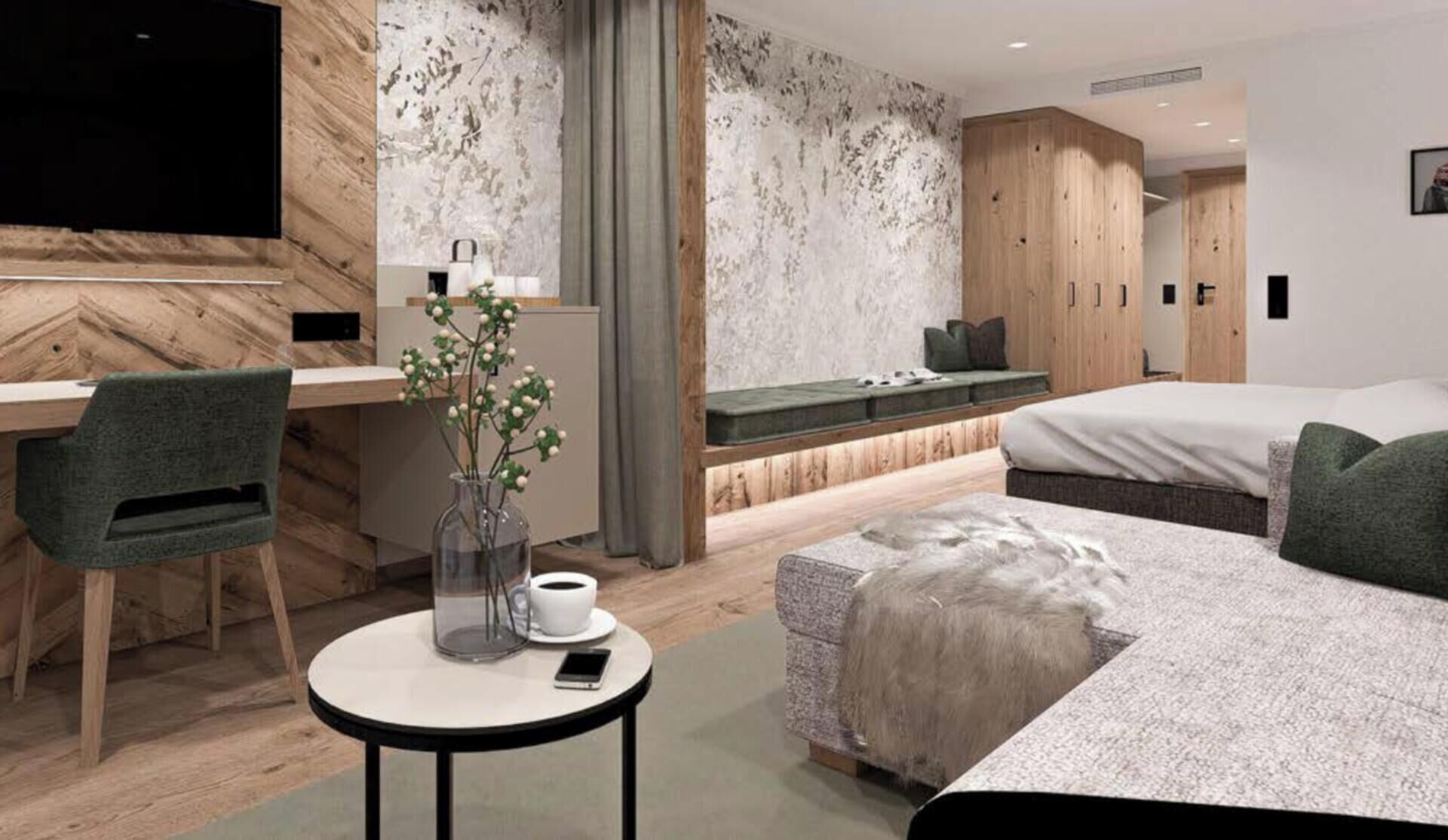 A modern hotel room with a bed, a desk, a chair, a small table with a vase and a cup, and a large mirror.