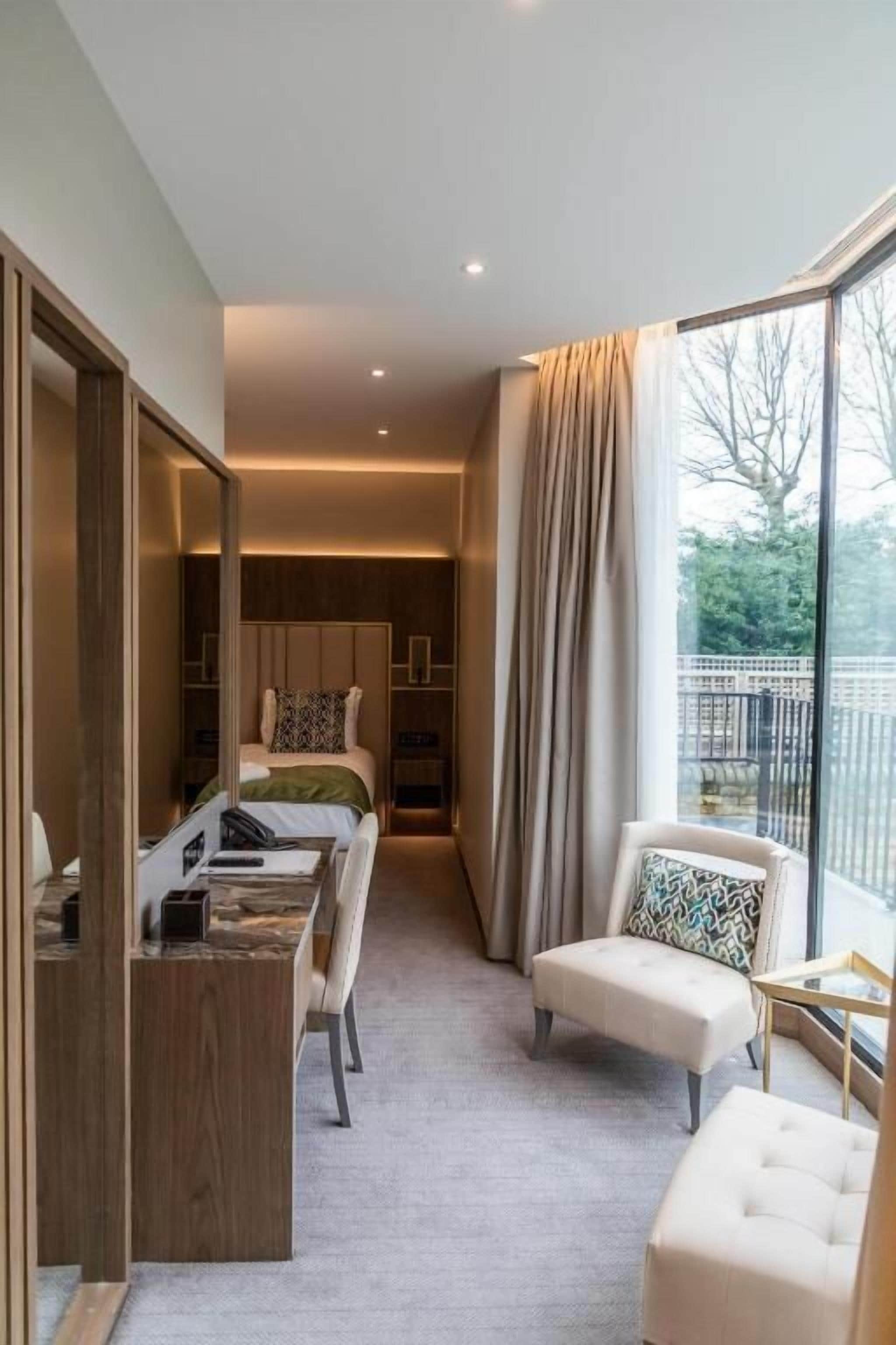 premium suite double/twin with a garden view | in-room safe, desk, laptop workspace, blackout curtains