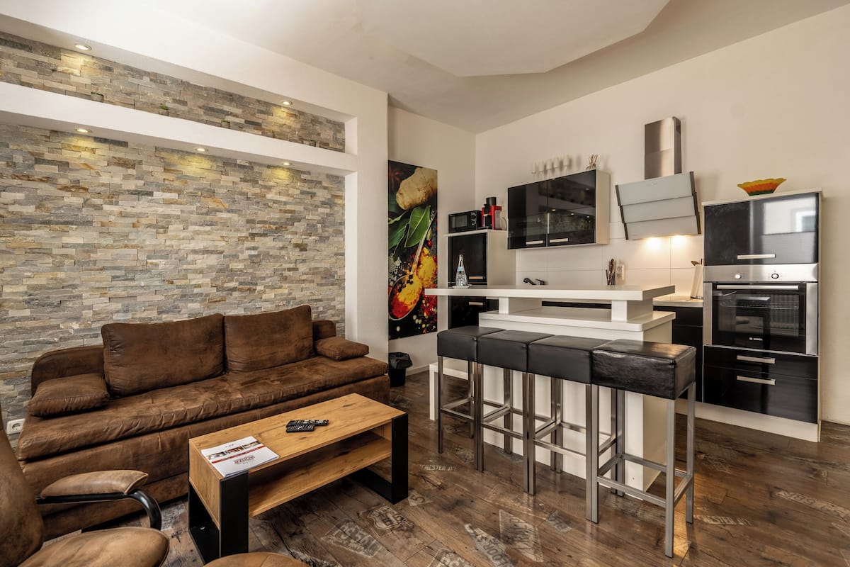 deluxe apartment, 1 queen bed with sofa bed | living area | 50-inch smart tv with cable channels