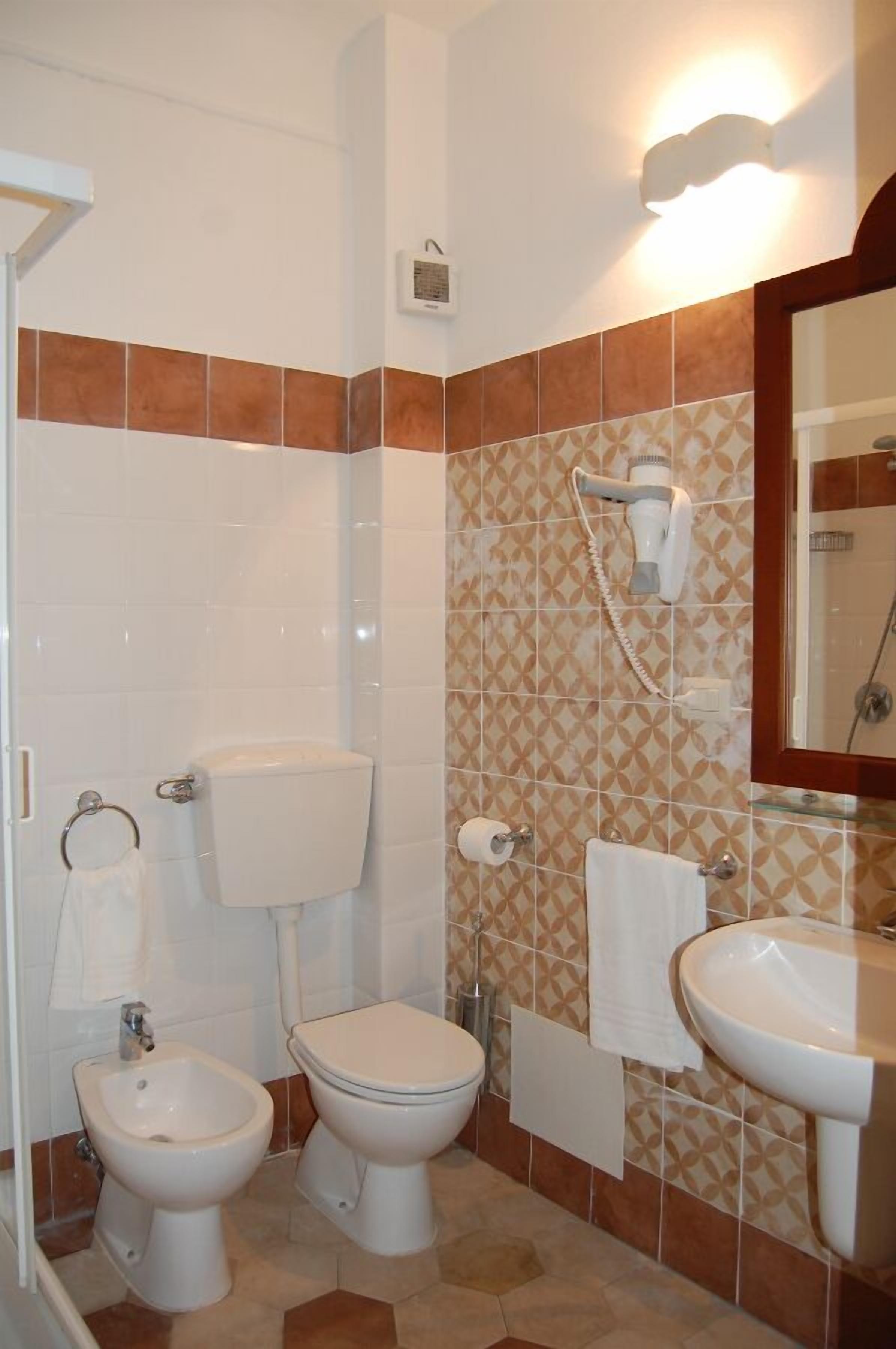 family room | bathroom | shower, rainfall showerhead, designer toiletries, hair dryer
