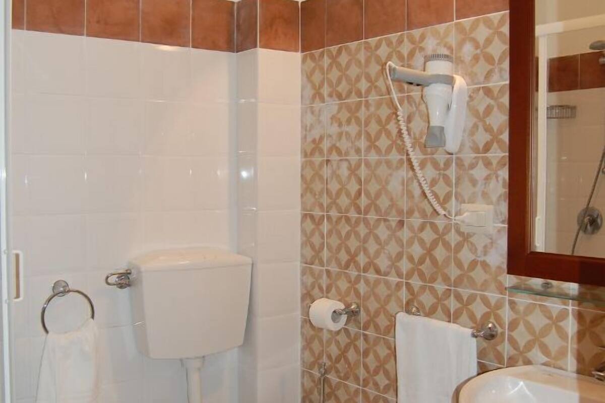 family room | bathroom | shower, rainfall showerhead, designer toiletries, hair dryer