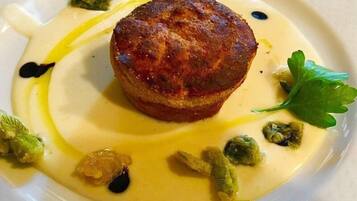Een bord met een muffin, saus en garnering.