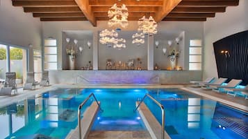 Relax by the pool, surrounded by comfortable seating and beautiful artwork.