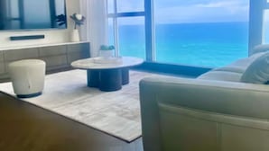 A modern living room with a large window offering a view of the ocean.