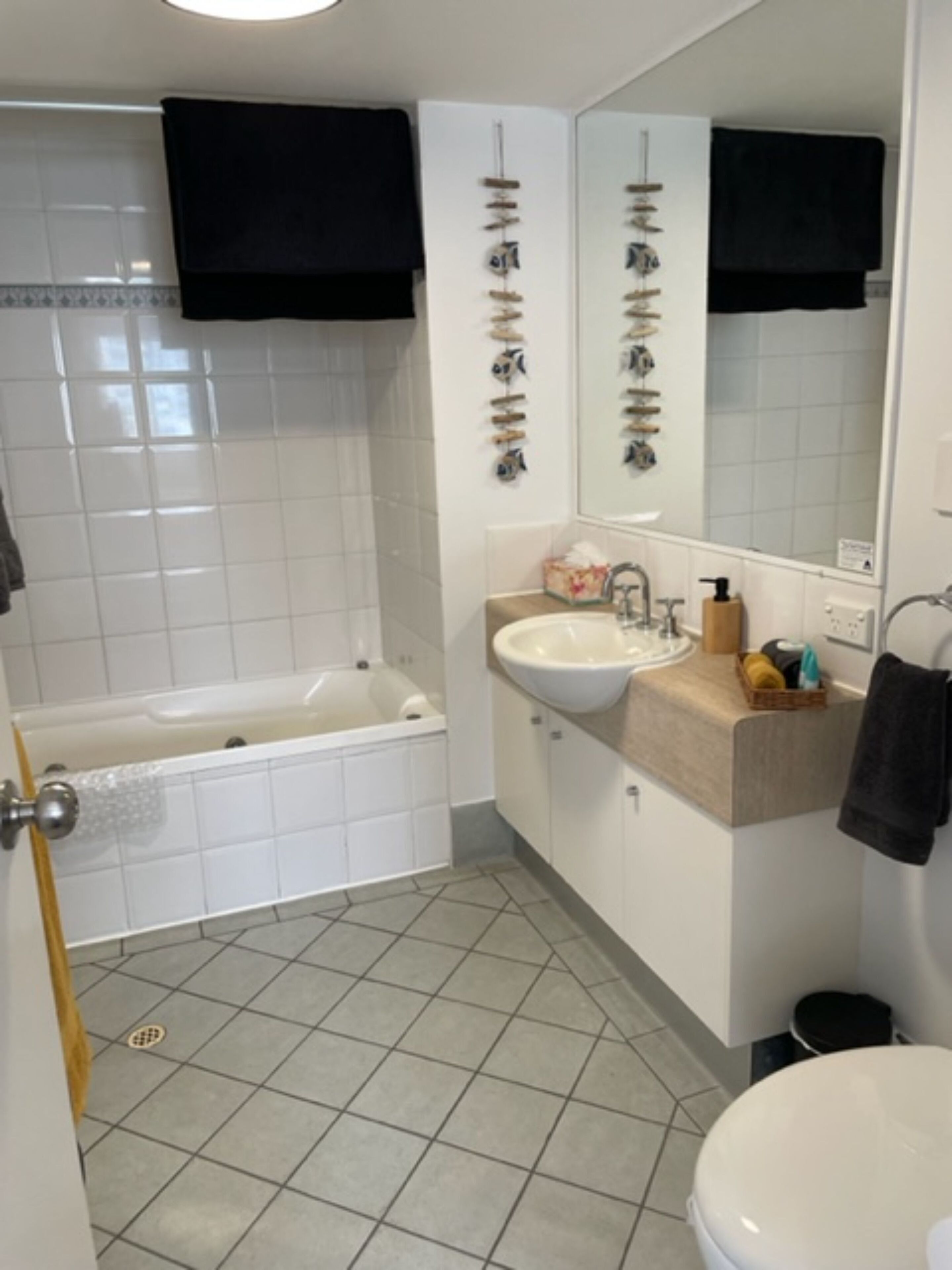 A bathroom with a bathtub, sink, and toilet.