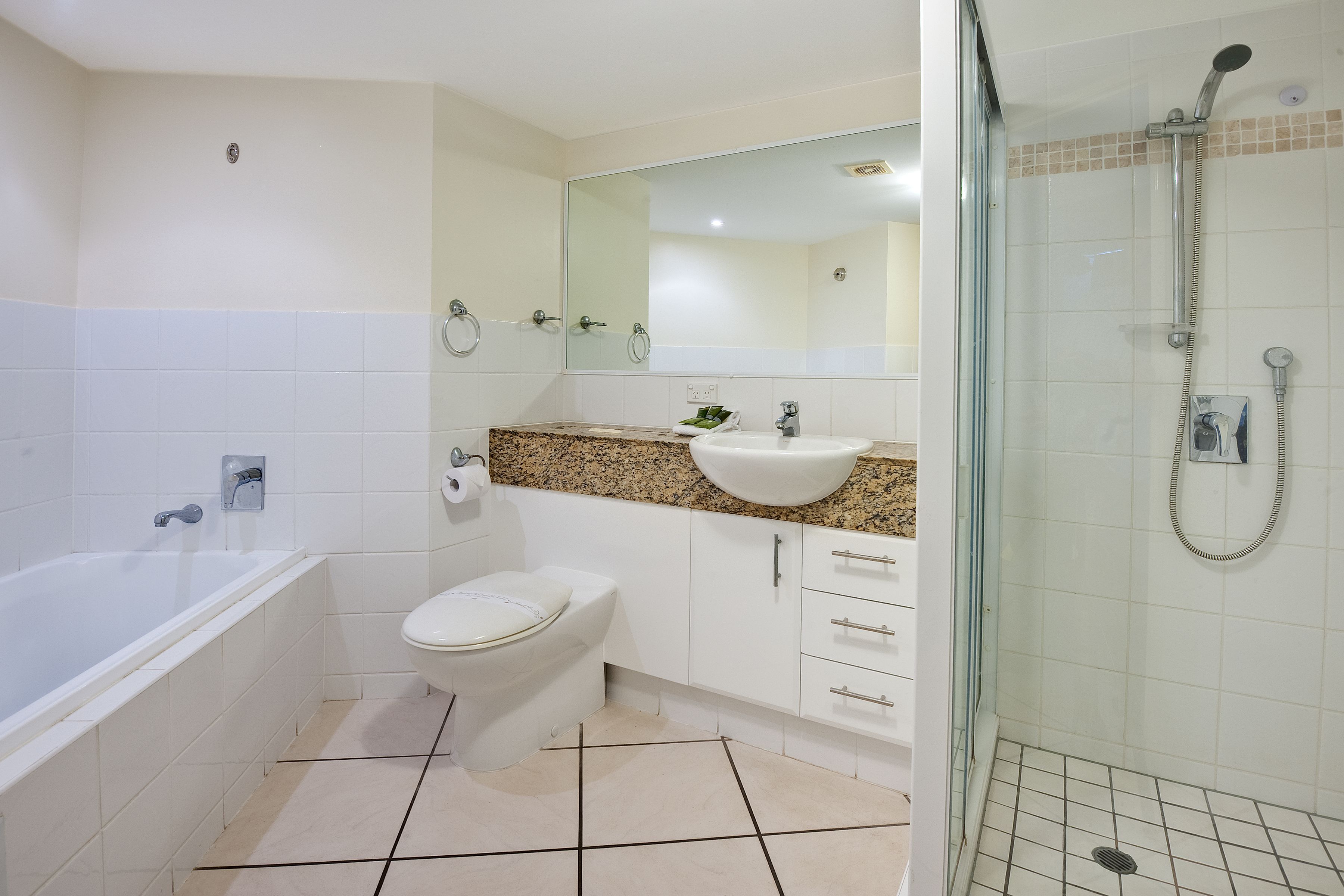 A bathroom with a bathtub, toilet, sink, and shower.