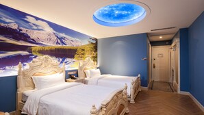 A bedroom with two beds, a skylight, and a mural of a mountain landscape.