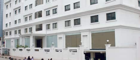 A multi-story hotel with a modern facade, multiple windows, and a prominent entrance.