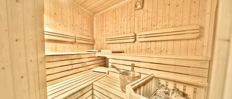 A sauna with wooden benches and a wooden wall with a clock.