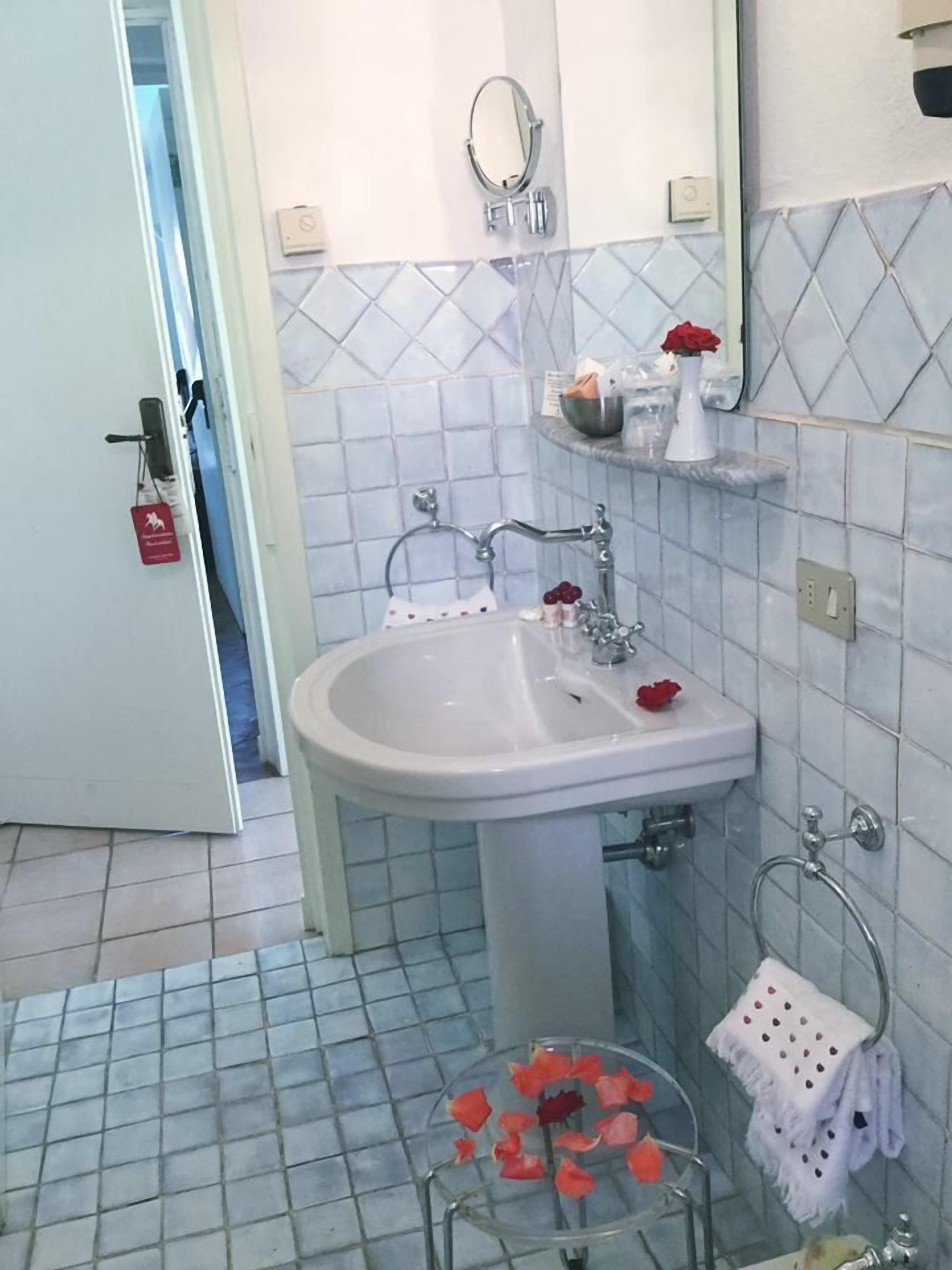 designer toiletries, hair dryer, bidet, towels