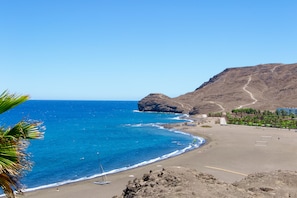 On the beach, black sand, beach towels, scuba diving