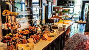 A buffet setup with various food items and utensils.