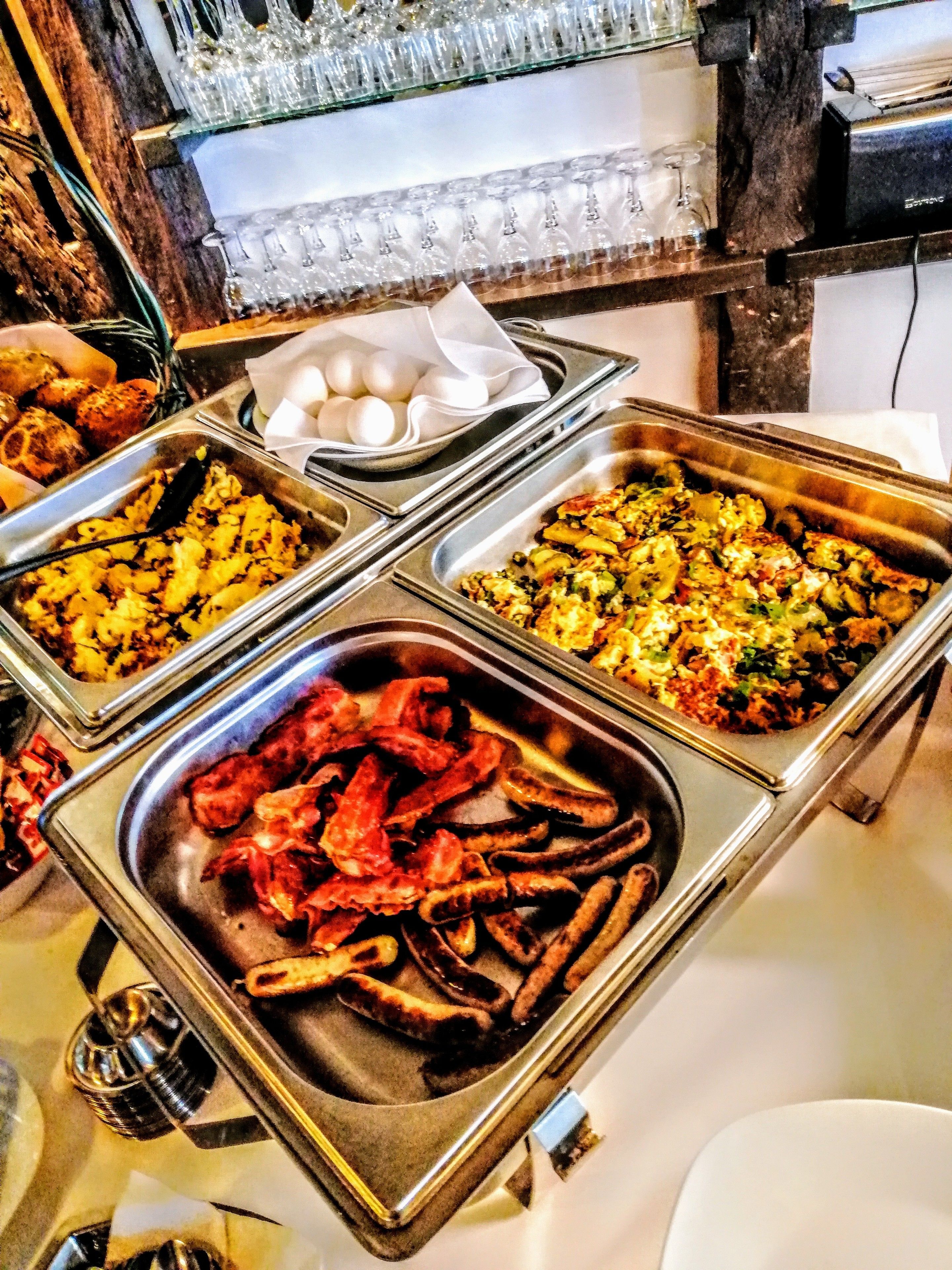A buffet with various dishes including seafood, salads, and eggs.