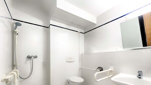 A modern bathroom with a shower, toilet, and sink. - B&B Hotel Köln-Frechen (Frechen)