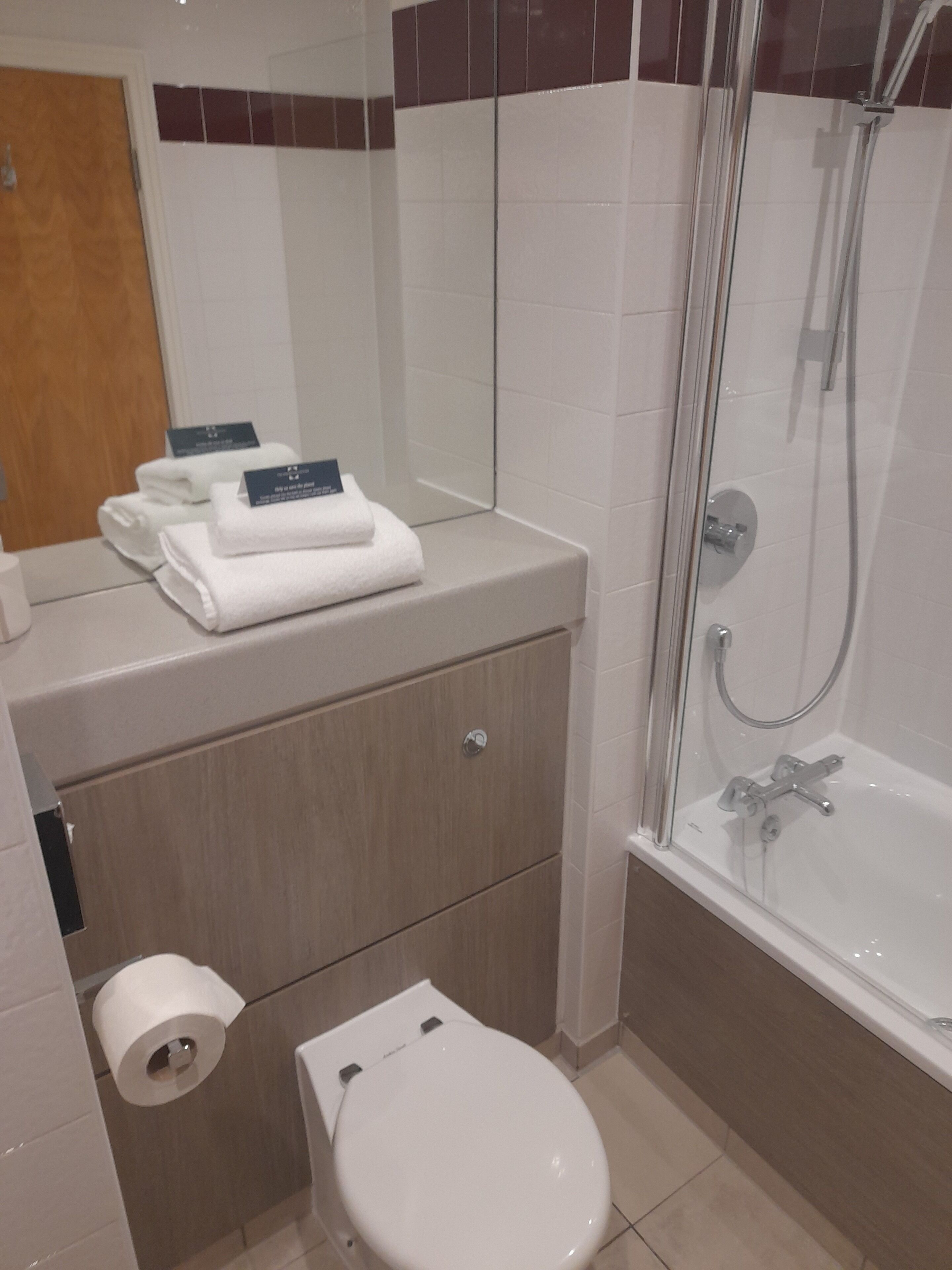 A bathroom with a toilet, sink, and shower.