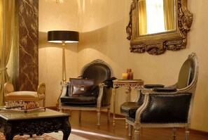 Relax in style with a grand armchair, plush chaise lounge, and elegant coffee table.
