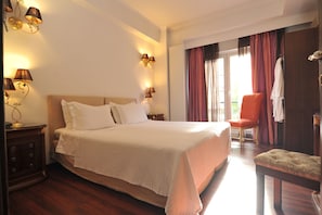 Relax in a spacious room with a large bed, nightstand, and seating area.