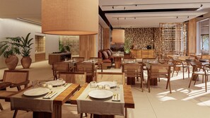 A spacious dining area with multiple tables set for meals, surrounded by wicker chairs and wooden tables. - PortoBay Falésia (Albufeira)