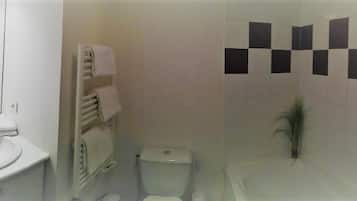 Kylpyhuone, jossa on pesuallas, wc ja kylpyamme.