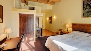 A hotel room with a bed, desk, chair, and a small kitchenette area. - Swans Brewery, Pub and Hotel (Victoria)
