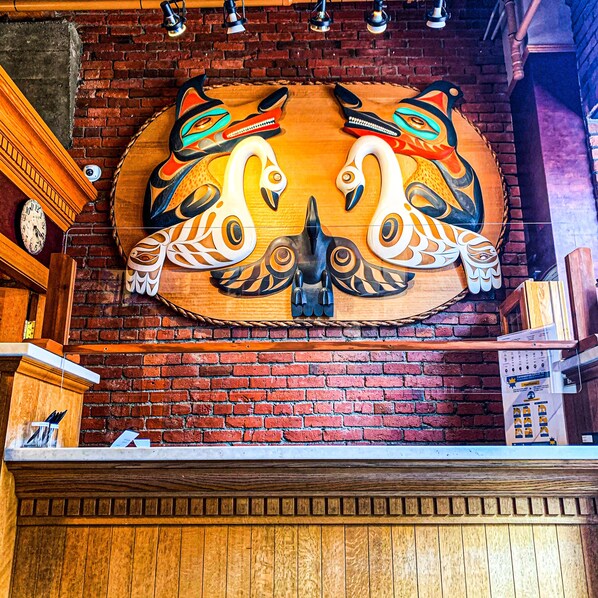 A wooden wall with a large, colorful mural of swans.