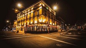 A brightly lit historic building with a corner entrance, large windows, and a street-facing facade. - Swans Brewery, Pub and Hotel (Victoria)