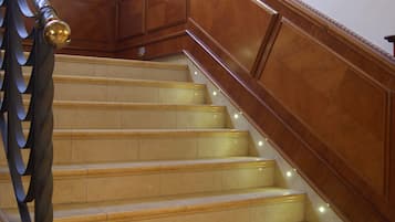 A grand staircase with a wooden handrail and a decorative balustrade.