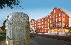 Un edificio histórico con un monumento de piedra en primer plano.