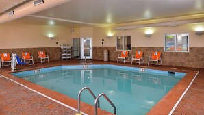An indoor swimming pool with clear lane markings, a changing room, and a door leading to an adjacent area. - Holiday Inn Express & Suites Cincinnati - Mason by IHG (Mason)