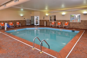 An indoor swimming pool with clear lane markings, a changing room, and a door leading to an adjacent area. - Holiday Inn Express & Suites Cincinnati - Mason by IHG (Mason)