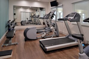 A gym with treadmills, elliptical machines, and free weights. - Holiday Inn Express & Suites Cincinnati - Mason by IHG (Mason)