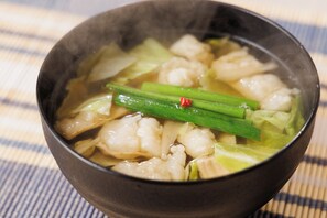 A bowl of soup with vegetables and a red chili pepper. - Canal City Fukuoka Washington Hotel (Fukuoka)